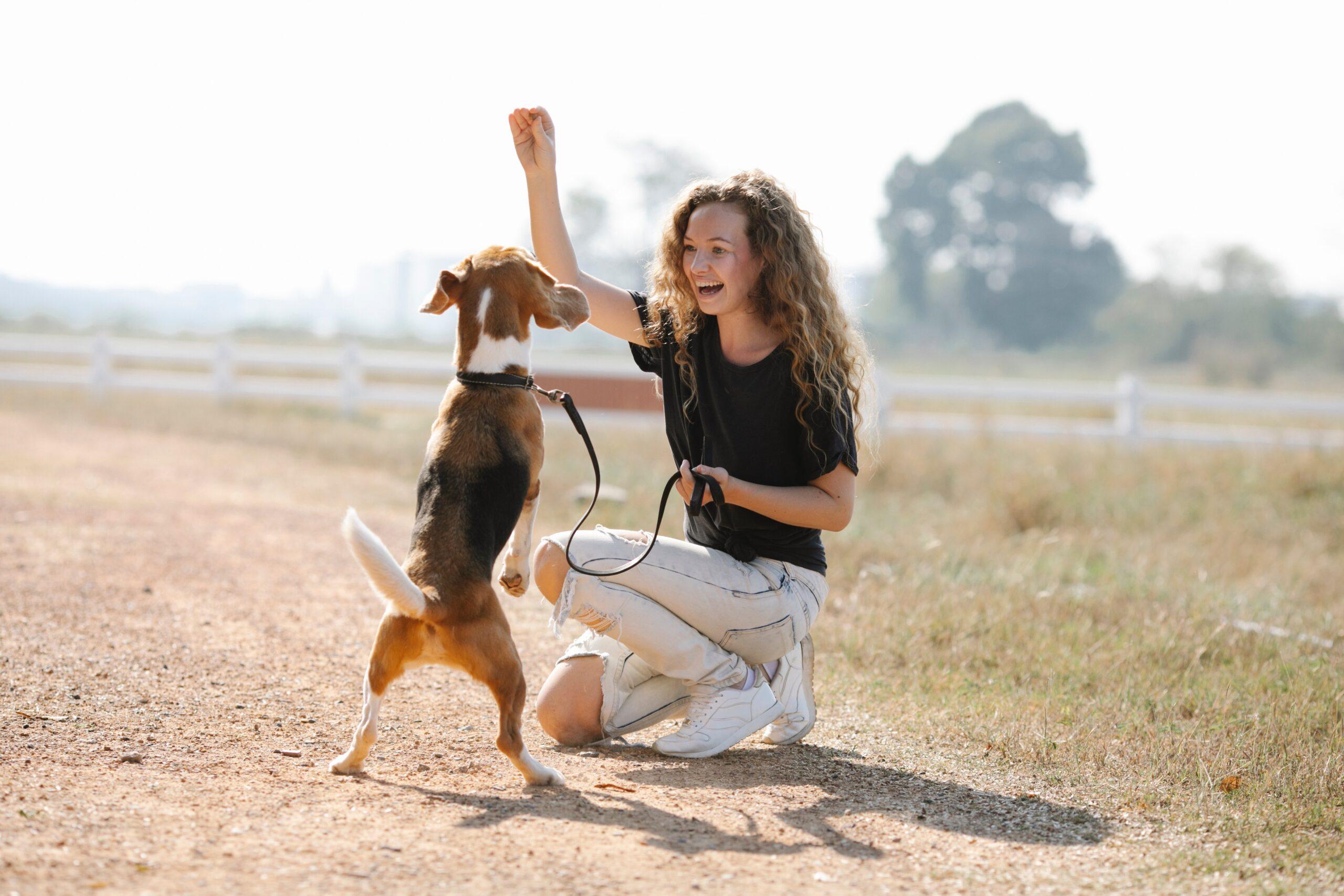 Excited woman training her dog